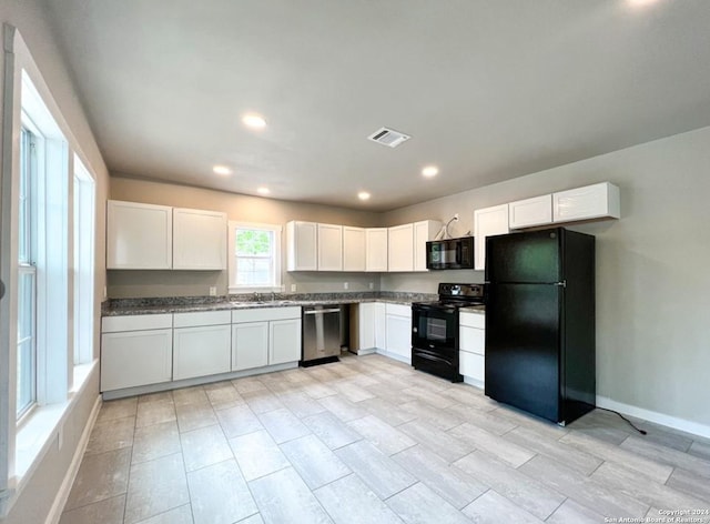 kitchen featuring white cabinetry, sink, and black appliances