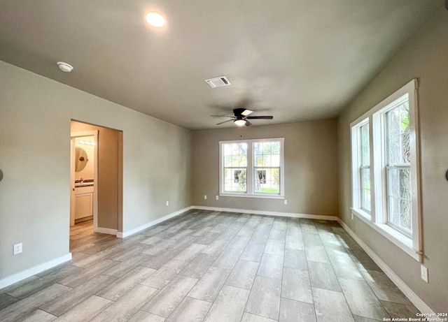 empty room featuring ceiling fan and light hardwood / wood-style flooring