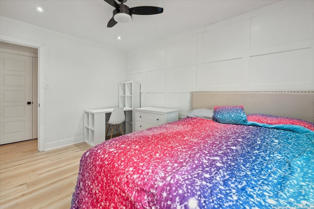 bedroom with ceiling fan and light hardwood / wood-style floors