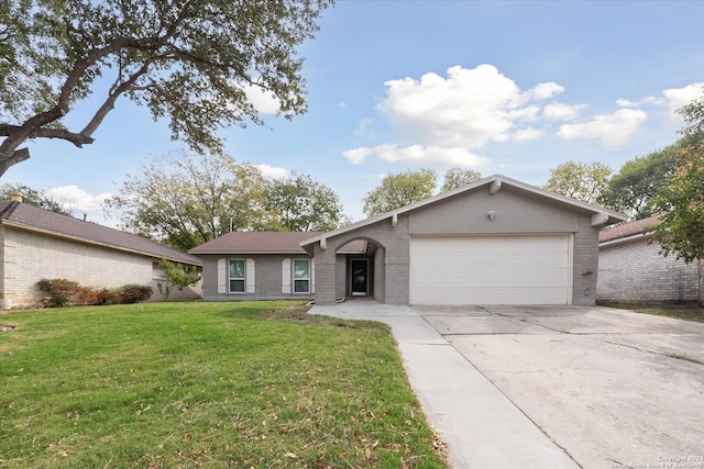 ranch-style house with a garage and a front lawn