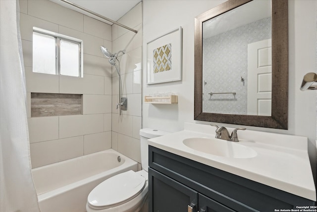 full bathroom featuring shower / bath combo with shower curtain, vanity, and toilet