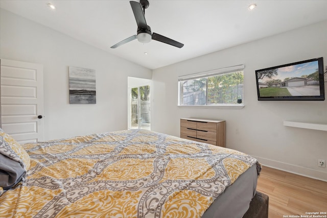 bedroom with light hardwood / wood-style flooring, ceiling fan, and lofted ceiling