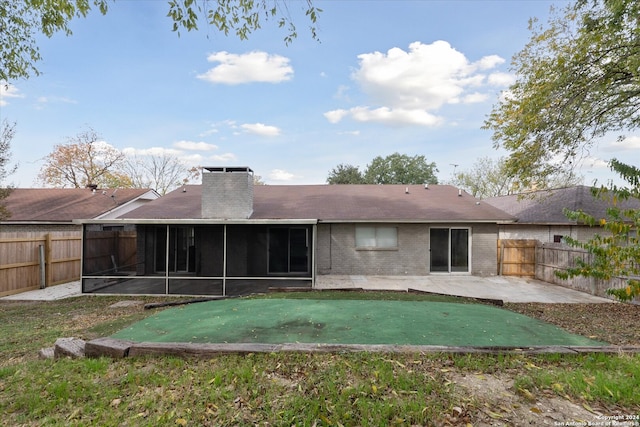 back of house featuring a patio and a sunroom