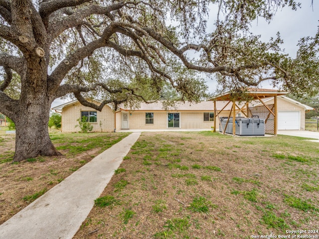 single story home with a jacuzzi and a front lawn