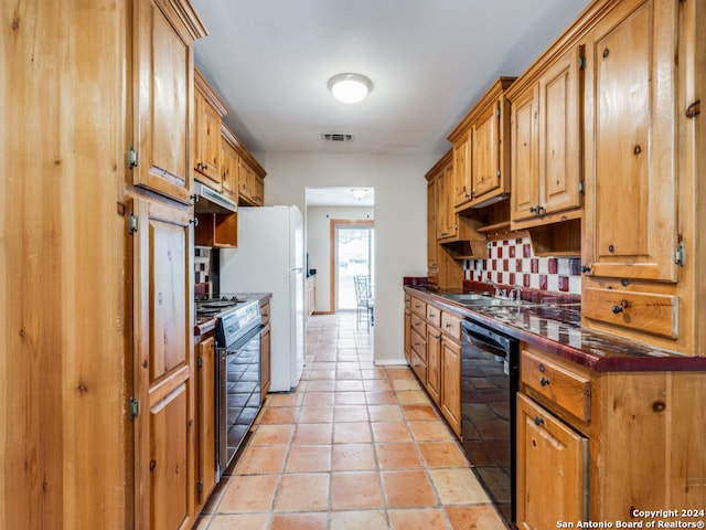 kitchen featuring stove, backsplash, sink, black dishwasher, and white fridge