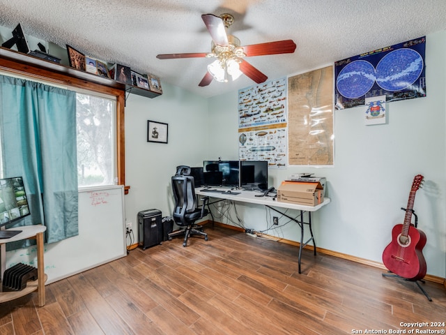 office space with hardwood / wood-style flooring, ceiling fan, and a textured ceiling