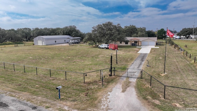 view of yard featuring a rural view and a garage