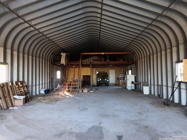 miscellaneous room featuring concrete flooring and vaulted ceiling