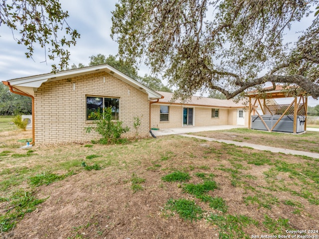 back of house with a yard and a patio area