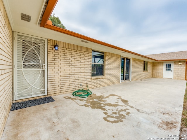 entrance to property featuring a patio area