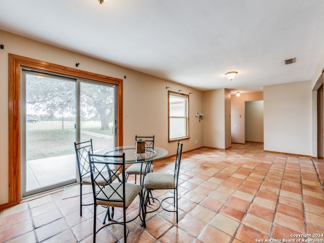 dining area with light tile patterned floors