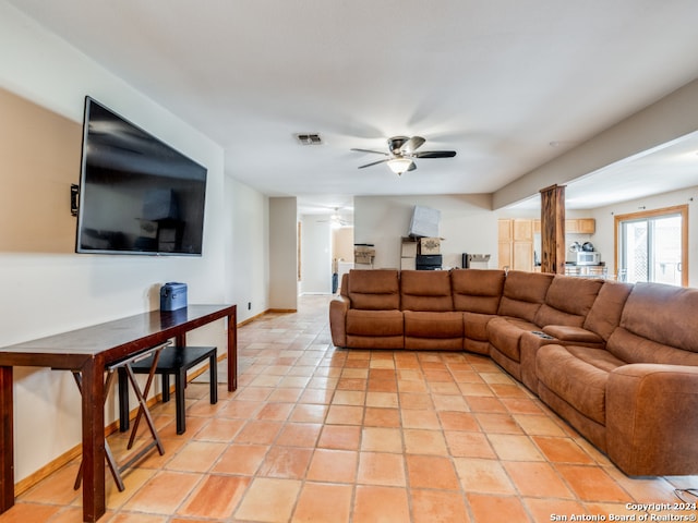 living room featuring ceiling fan and light tile patterned floors