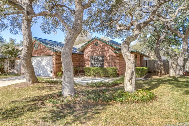 view of front of property with a garage and a front lawn