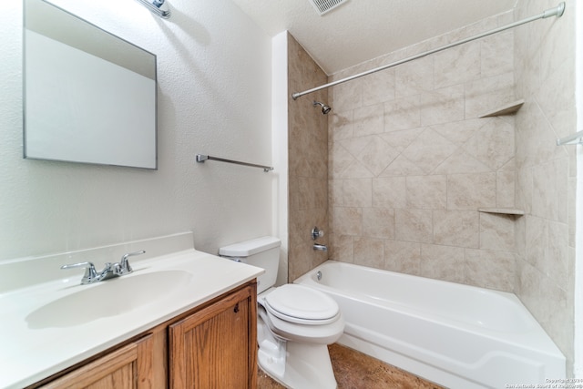 full bathroom with vanity, a textured ceiling, tiled shower / bath combo, and toilet