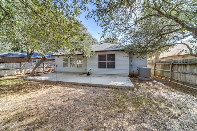rear view of house with central air condition unit and a patio area