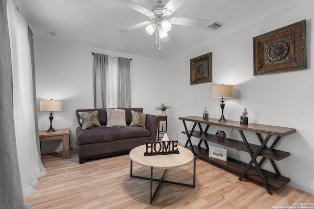 living room with light hardwood / wood-style flooring and ceiling fan