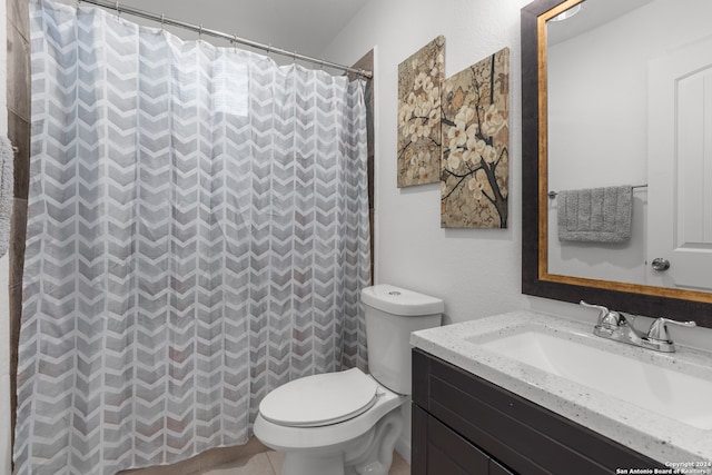 bathroom featuring tile patterned floors, vanity, toilet, and walk in shower