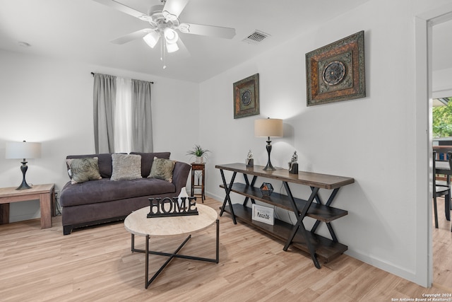 living room featuring ceiling fan and light wood-type flooring