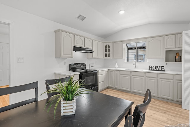 kitchen with light wood-type flooring, gray cabinetry, sink, black / electric stove, and lofted ceiling