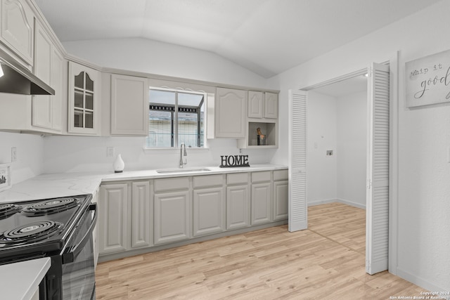 kitchen featuring sink, wall chimney range hood, light hardwood / wood-style flooring, black / electric stove, and vaulted ceiling