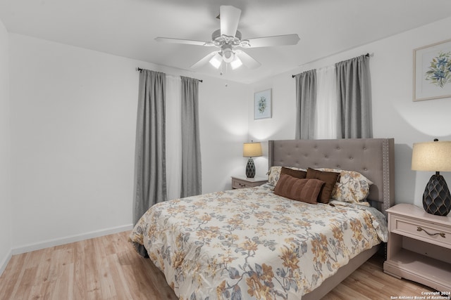 bedroom with light hardwood / wood-style floors and ceiling fan