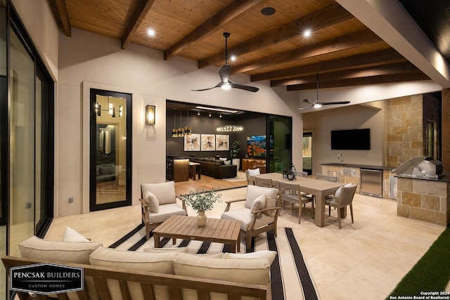 interior space with outdoor lounge area, an outdoor kitchen, ceiling fan, and grilling area