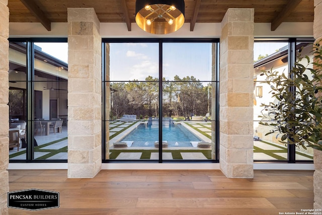 entryway with beamed ceiling, wood ceiling, and hardwood / wood-style flooring