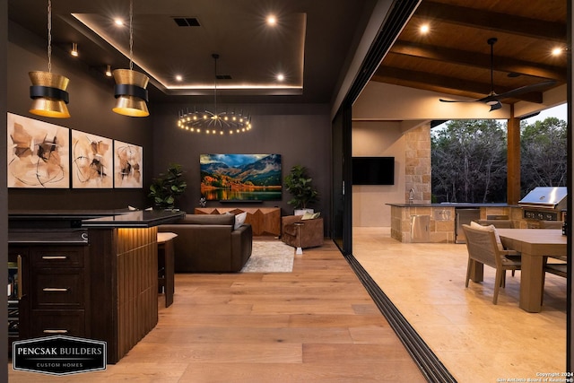 home theater featuring wood ceiling, ceiling fan with notable chandelier, high vaulted ceiling, beamed ceiling, and light hardwood / wood-style floors