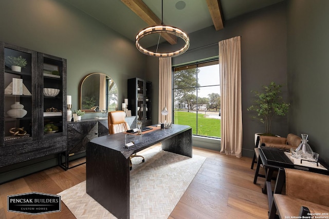 home office with beamed ceiling, a towering ceiling, and light hardwood / wood-style flooring