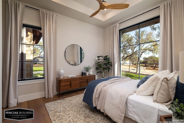 bedroom featuring access to outside, ceiling fan, and dark hardwood / wood-style floors