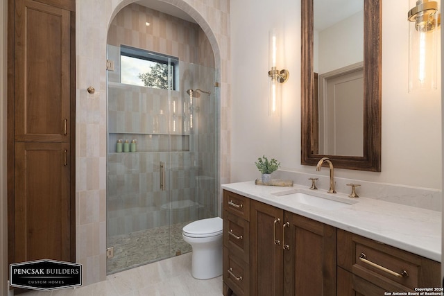 bathroom featuring vanity, toilet, and an enclosed shower