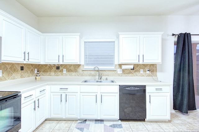 kitchen with sink, light tile patterned floors, tasteful backsplash, white cabinets, and black appliances