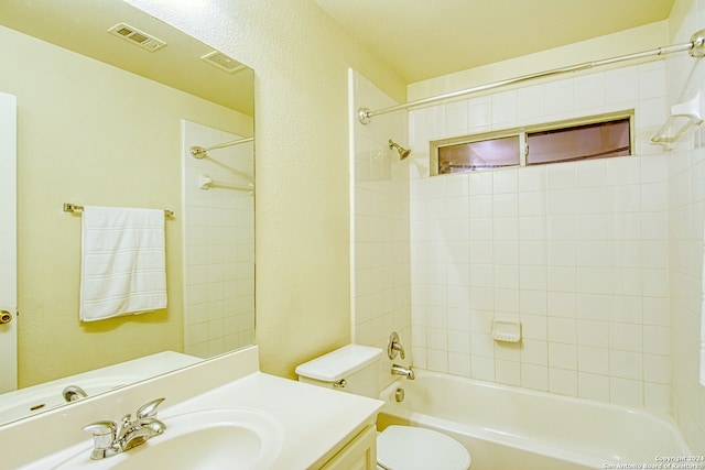 full bathroom featuring vanity, toilet, and tiled shower / bath