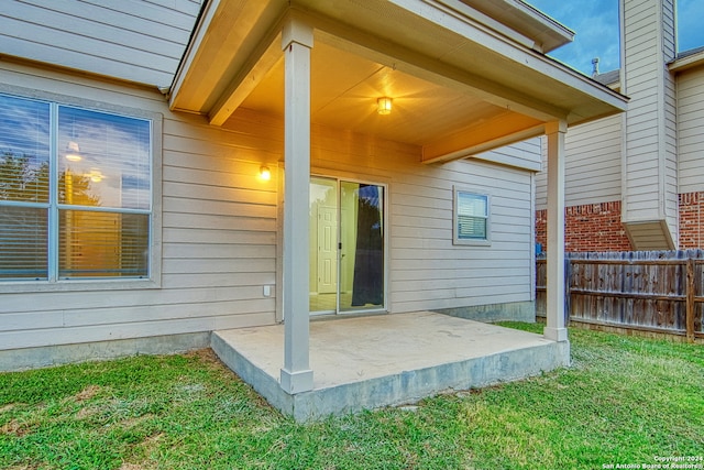 view of exterior entry with a patio