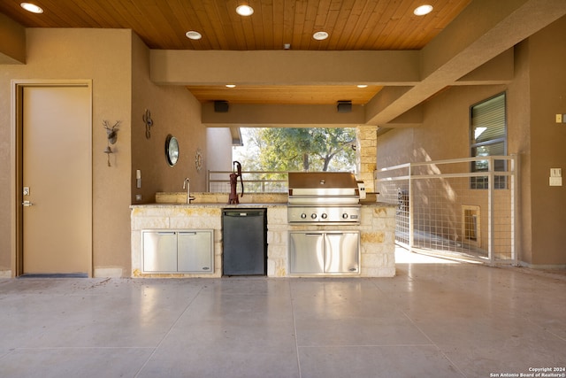 view of patio featuring sink, an outdoor kitchen, and a grill