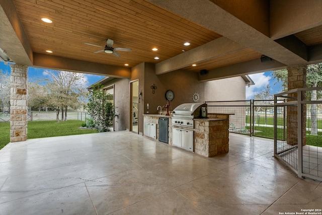 view of patio featuring sink, an outdoor kitchen, ceiling fan, and a grill