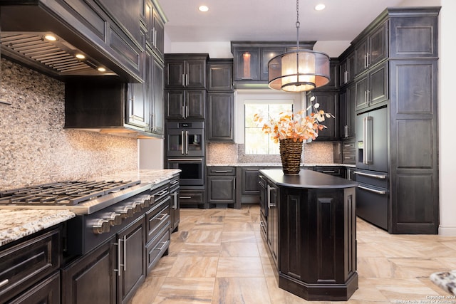 kitchen with a center island, hanging light fixtures, appliances with stainless steel finishes, tasteful backsplash, and custom range hood