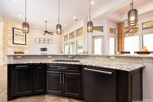 kitchen featuring ceiling fan, dishwasher, pendant lighting, and sink