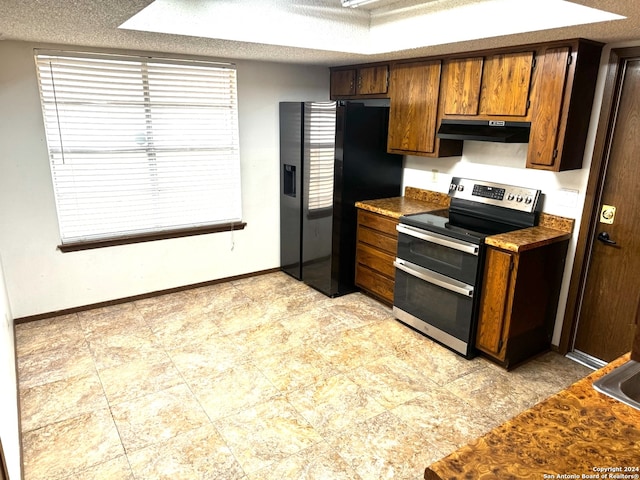 kitchen with a textured ceiling, black refrigerator with ice dispenser, and electric stove