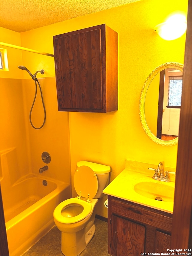 full bathroom with tile patterned flooring, a textured ceiling, toilet, shower / washtub combination, and vanity