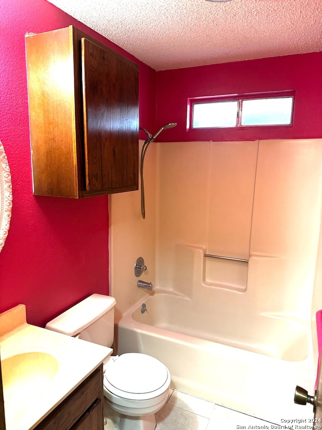 full bathroom featuring tile patterned flooring, a textured ceiling, toilet, vanity, and shower / bathtub combination