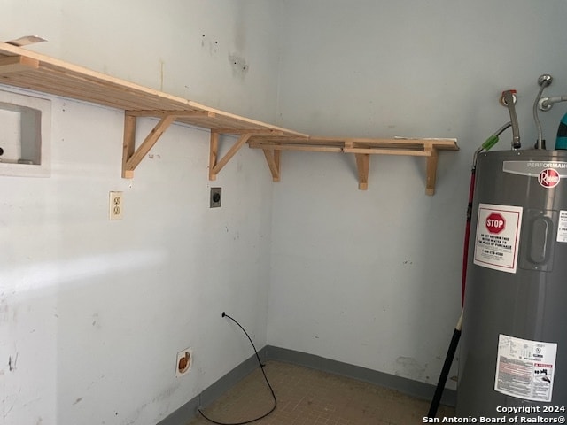 clothes washing area featuring electric water heater, hookup for a washing machine, and hookup for an electric dryer