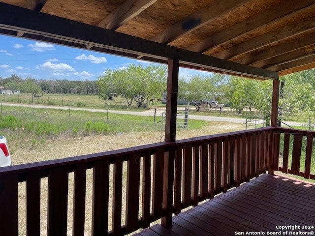 wooden deck with a rural view