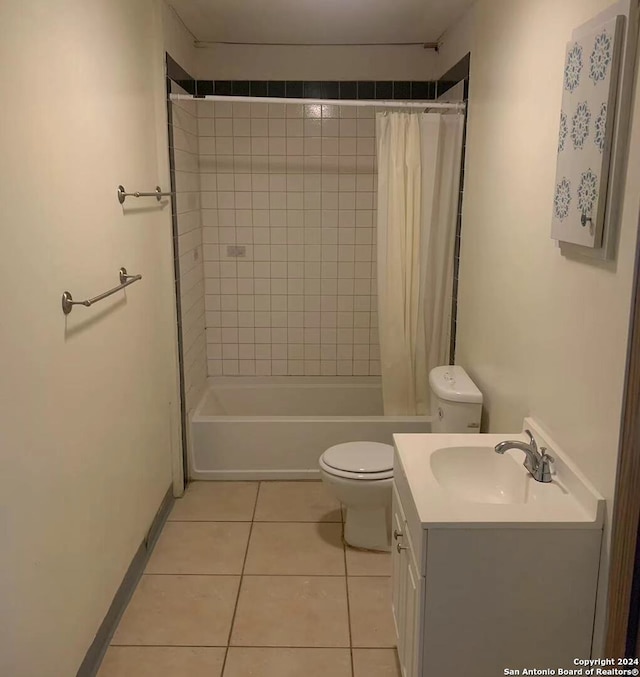 full bathroom with tile patterned floors, shower / bathtub combination with curtain, vanity, and toilet