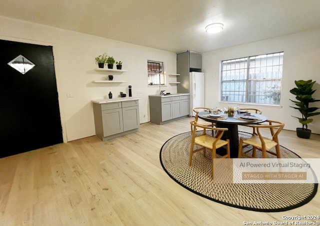 dining area featuring sink and light wood-type flooring