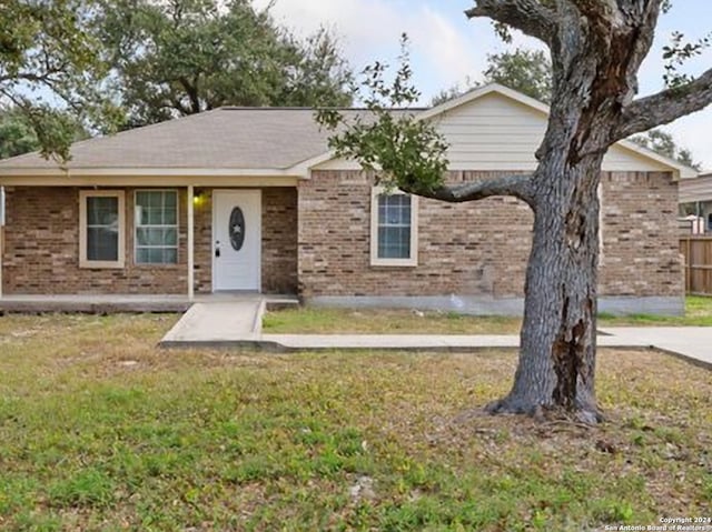 ranch-style home with a front lawn