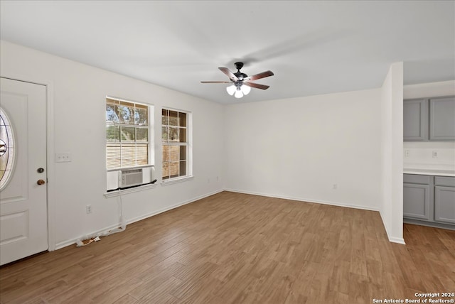 entrance foyer featuring light wood-type flooring, ceiling fan, and cooling unit