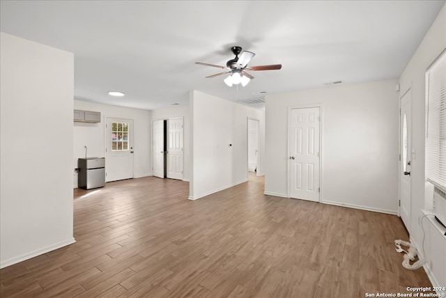 unfurnished room with light hardwood / wood-style flooring and ceiling fan