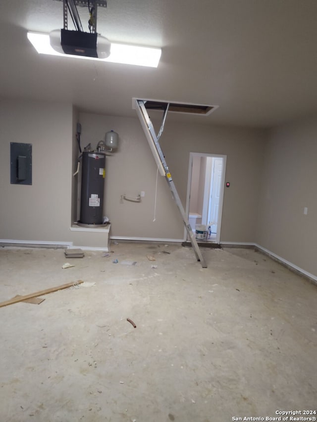 garage with electric panel, a garage door opener, and water heater