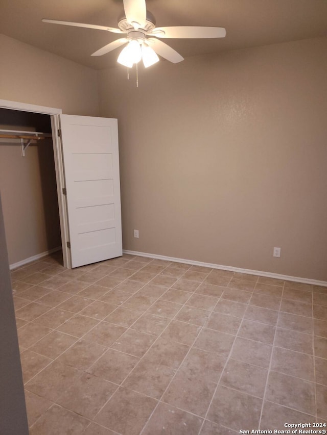 unfurnished bedroom featuring ceiling fan, light tile patterned floors, and a closet